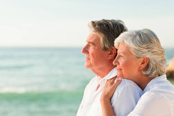 Woman hugging her husband at the beach